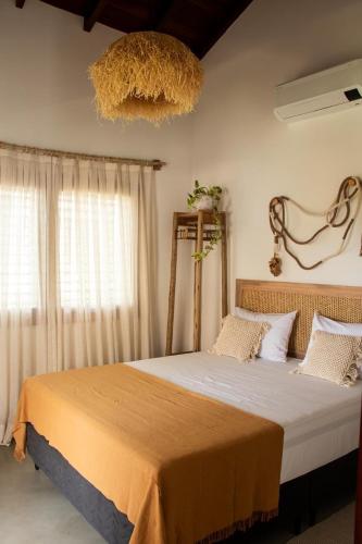 a bedroom with a large bed in a room at Casa Cajú in Cruz