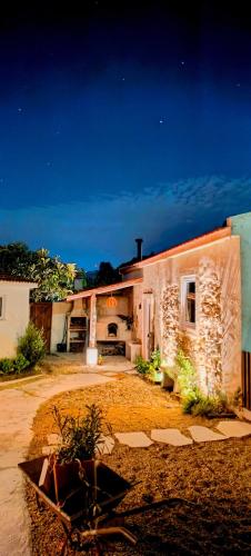 a stone house with a yard in front of it at AMEIO - Country House in Rio Maior