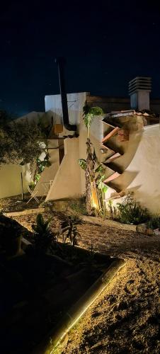 a building with a skateboard ramp in a yard at night at AMEIO - Country House in Rio Maior