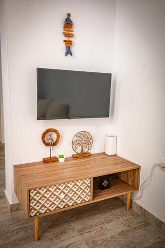a living room with a tv on a wall at Skiathos Pearl in Skiathos Town