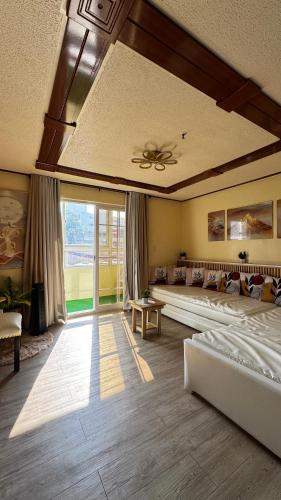 a large bedroom with beds and a ceiling fan at WPY Condotel in Baguio