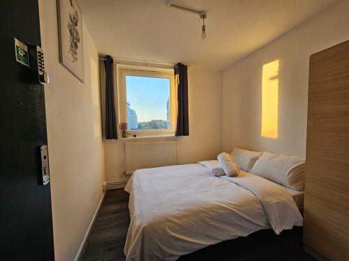 a bedroom with a bed and a window at Wapping Stay in London