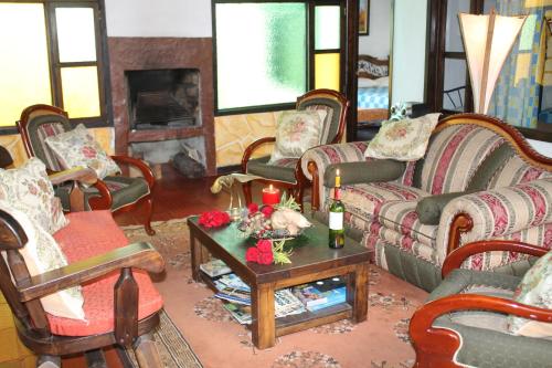 a living room with couches and a table with candles at Hospedaje La Casona in Tabio