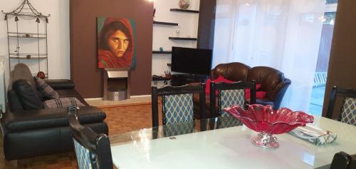 a living room with a table with chairs and a painting at 2 Bed semi-detached house in Poole