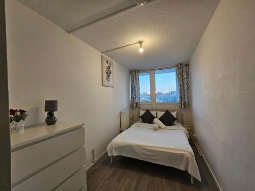 a small bedroom with a bed and a window at Wapping Stay in London
