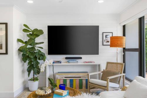 a living room with a flat screen tv on a wall at New! Luxurious Villa with Pool in West Palm Beach in Ibis Isle