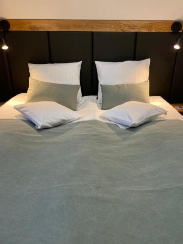 a large bed with two pillows on top of it at Naturalna Cisza in Michałkowa