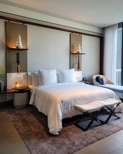 a large bedroom with a large bed and a couch at The Stone Hotel in Dargai