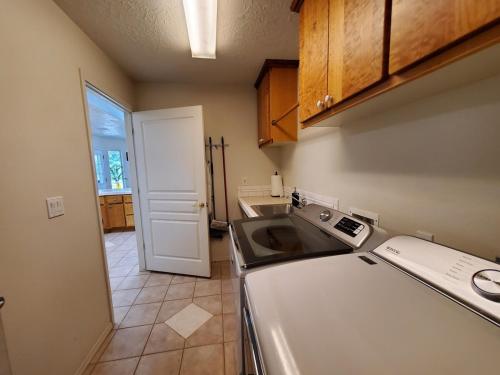 a kitchen with a sink and a dishwasher at Windmill Ranch in Chino Valley