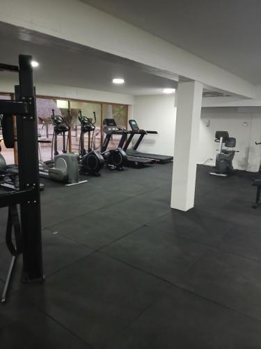 a gym with several treadmills and exercise machines at Relaxing Suite Coronado, Panamá in Chame