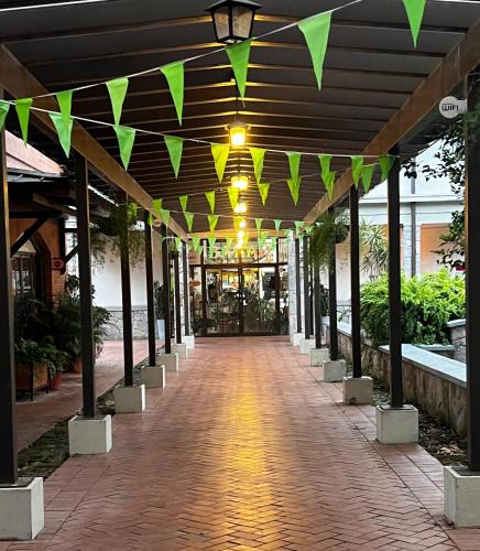 a hallway with yellow and green triangular flags at Paseo Suites El Valle, Luxury Apartments in Valle de Anton