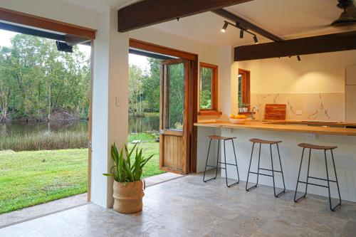 a kitchen with bar stools and a view of a lake at The Lake House in Mission Beach