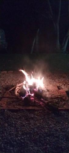a fire is burning on the ground at night at Cabana in Annitapolis