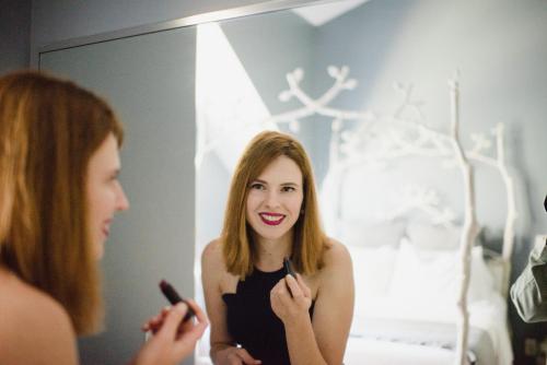 a woman brushing her teeth in front of a mirror at Getaway Inn at Cooper's Woods in Put-in-Bay