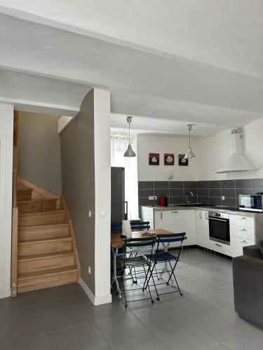 a kitchen and dining room with a table and chairs at Mazet de Jade in Vallon-Pont-dʼArc