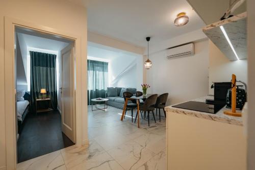 a kitchen and living room with a table and chairs at Apartments with a parking space Imotski, Zagora - 23873 in Imotski
