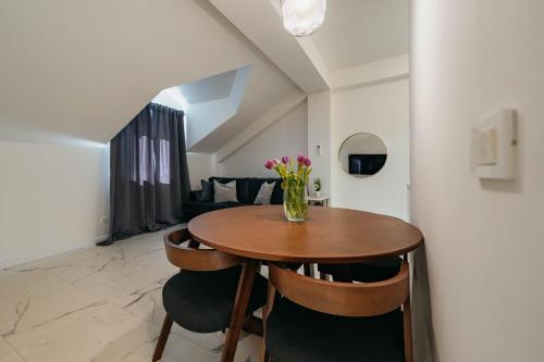 a dining room table with chairs and a vase of flowers at Apartments with a parking space Imotski, Zagora - 23873 in Imotski
