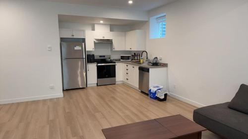 an empty kitchen and living room with a couch at Basement suite -Langley Willoughby in Langley