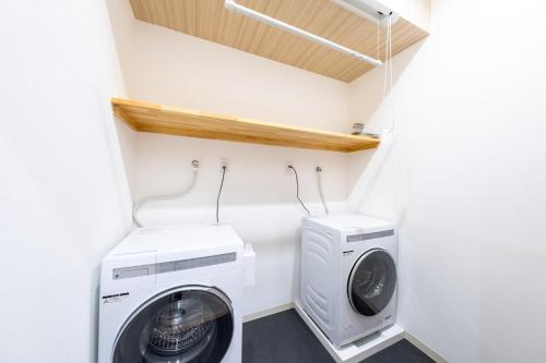 a small laundry room with a washer and dryer at 250平米 ベッド17台 4Bathroom Free Netflix Expo USJへ約10分 in Osaka