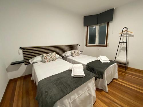 a room with two beds and a ladder in it at A dos Pasos in Caldas de Reis