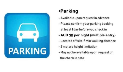 a sign that says parking with a white car at Platinum City Serviced Apartments in Melbourne