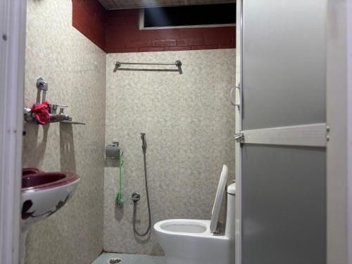a small bathroom with a toilet and a sink at Thapa Home Stay in Pokhara