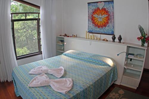 a bedroom with a bed with bows on it at Venere - Bed and Breakfast in Florianópolis