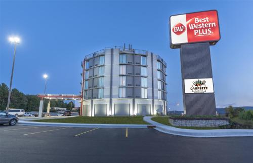 a building in a parking lot with a best western plus sign at Best Western Plus Wausau Tower Inn in Wausau