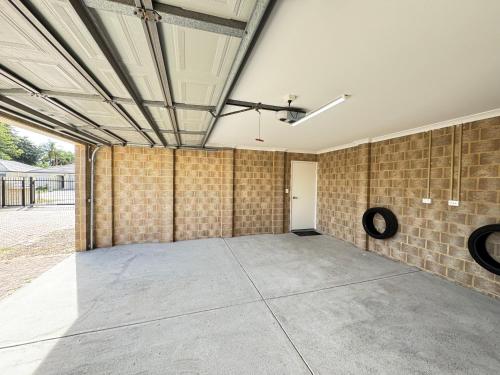 an empty room with a brick wall and a ceiling at Blissful Modern Home in Perth