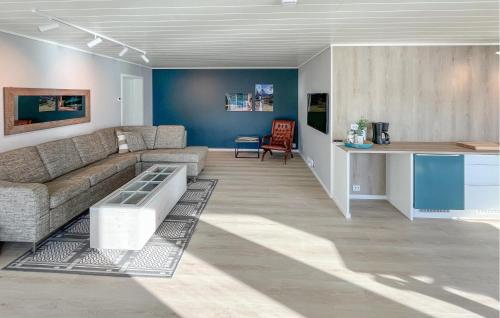 a living room with a couch and a table at Solhavn in Eidsvåg