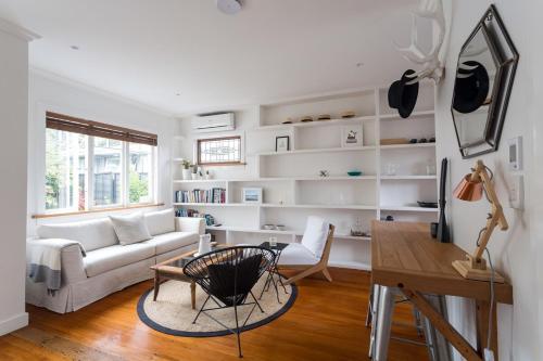 a living room with a couch and a table at Kohimarama Beach 2 Bedroom Charmer in Auckland