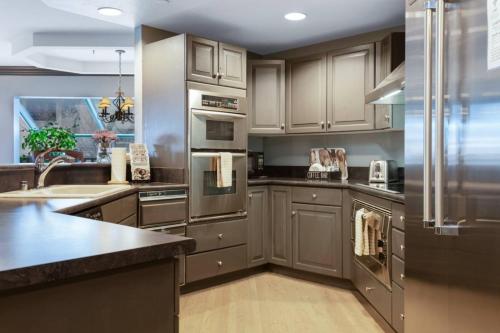 a kitchen with stainless steel appliances and a sink at Chic 3 Bedroom Beaver Creek Lodge Residence in Beaver Creek