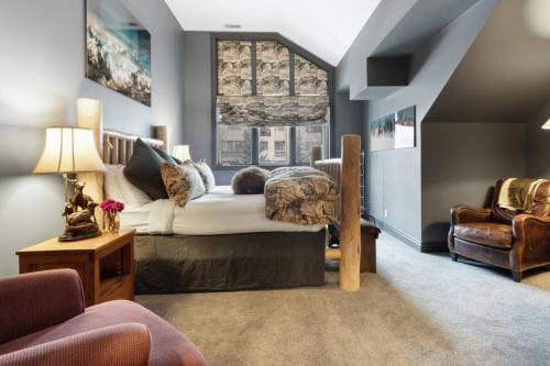 a bedroom with a large bed and a chair at Chic 3 Bedroom Beaver Creek Lodge Residence in Beaver Creek