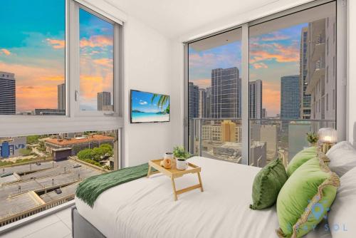 a bedroom with a large window with a view of a city at Beautiful 2BR Apartment with gym and Pool in Miami