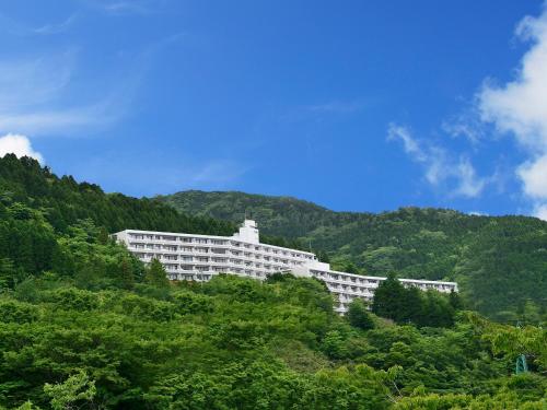 a large white building on the side of a mountain at Fourtreat Hakone Sengokuhara in Hakone