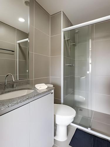 a bathroom with a shower and a toilet and a sink at Nik Perdizes in Sao Paulo
