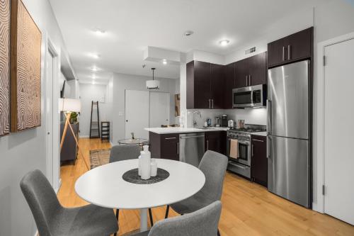 a kitchen and dining room with a table and chairs at Stylish 2BR Apartment in the Heart of East Village in New York