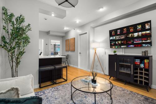 a living room with a table and a bar at Stylish 2BR Apartment in the Heart of East Village in New York
