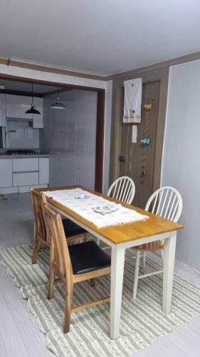 a dining room table and chairs in a kitchen at Happy Stay in Gyeongju