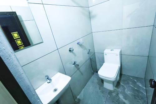 a bathroom with a toilet and a sink at kallungal square - Edapally in Ernakulam