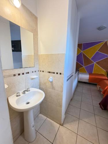 a bathroom with a sink and a mirror at Alojamientos Vm in Villa María
