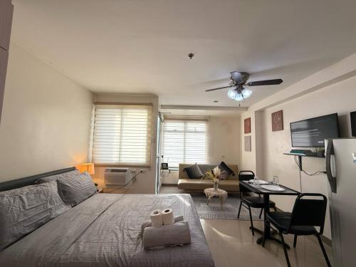 a bedroom with a bed and a living room at City Center Studio Unit Mountain View in Cebu City
