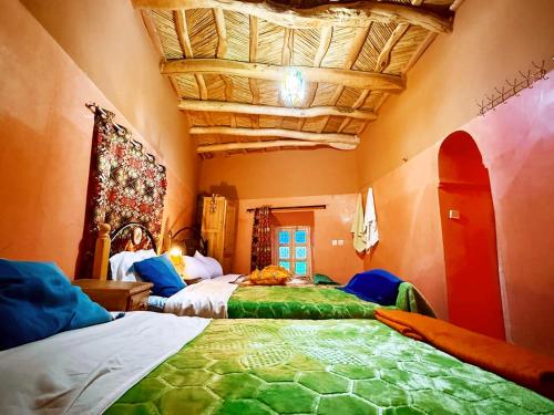 a bedroom with two beds in a room at DAR Moha dades in Aït Ougliff