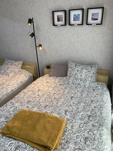a bedroom with two beds and two pictures on the wall at あびこハウス ABIKO House in Osaka