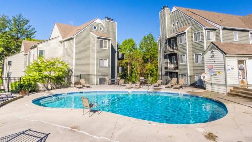a swimming pool in front of a house at Romantic Exclusive Condo Stunning Mountain View in Gatlinburg