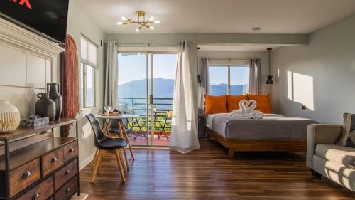 a bedroom with a bed and a view of the ocean at Romantic Exclusive Condo Stunning Mountain View in Gatlinburg