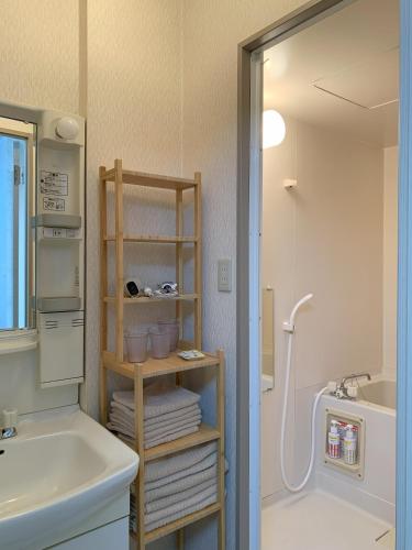 a bathroom with a sink and a toilet and a shower at あびこハウス ABIKO House in Osaka