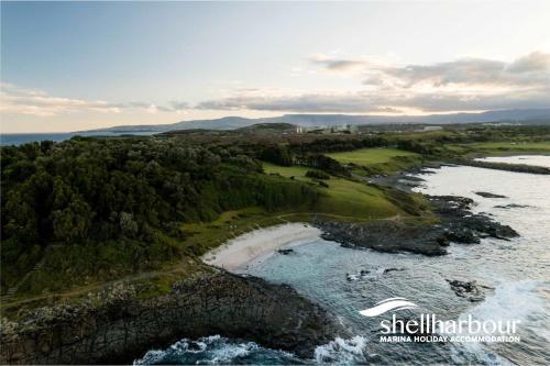 an aerial view of a beach and the ocean at Seaside Village Retreat in Shellharbour