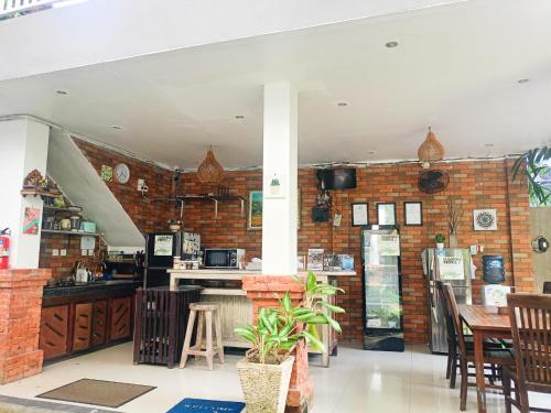 a kitchen with a brick wall and a table at Agatha Canggu in Canggu