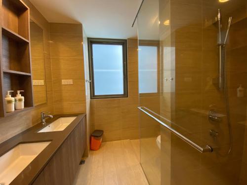 a bathroom with a glass shower and a sink at By The Sea with Side Seaview n Sunset view #3A2 in Batu Ferringhi